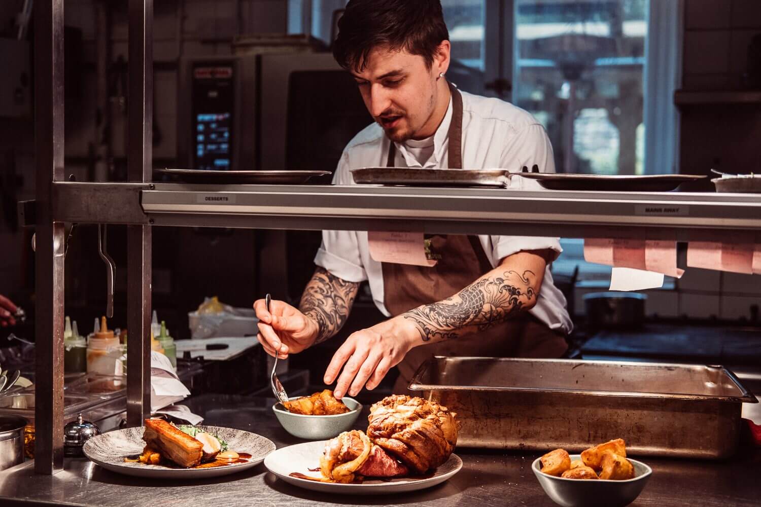 Head Chef Shaun Jones at the pass, plating Sunday lunches. En Voyage!