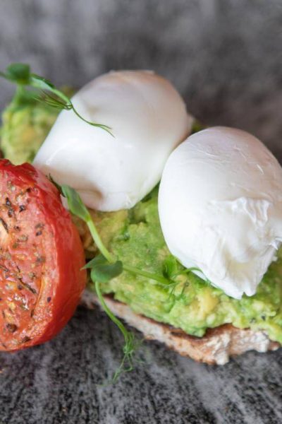 Avocado on toast with poached eggs, a lighter breakfast option at The Burleigh Court