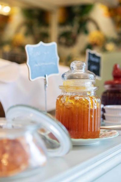 Assorted preserves and breads displayed on a side table for breakfast